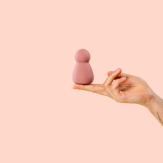 Bullet vibrator balancing on finger tips sex toy